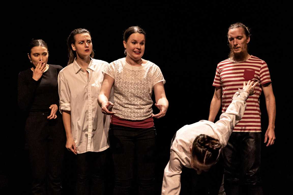 Mimes standing in a row on stage, Eliška taking a bow while others looking at her surprised and wondering.