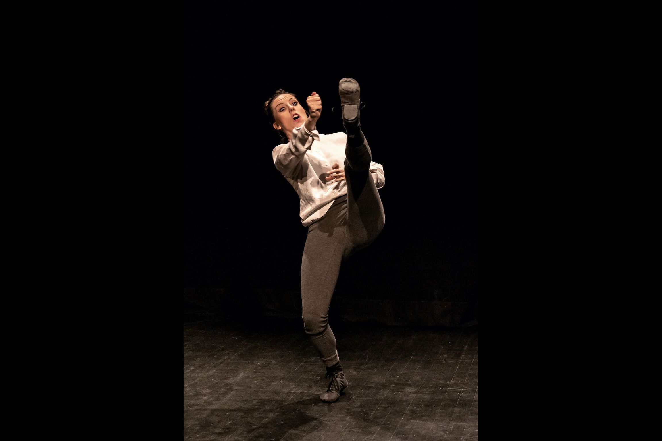 Eliška standing with her leg straight in front of her, aiming at her toe.
