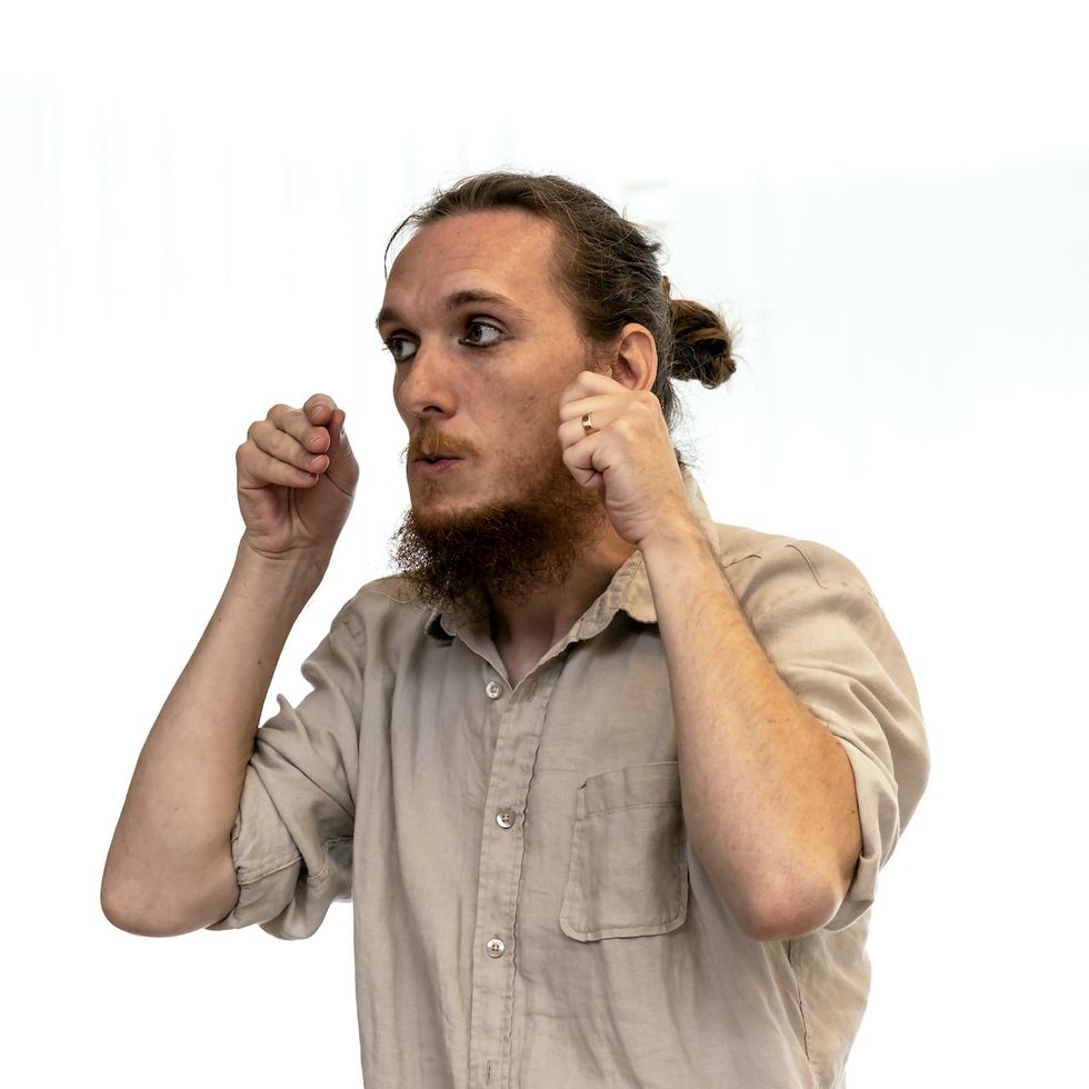 Tomaš putting an imaginary mask on his face
